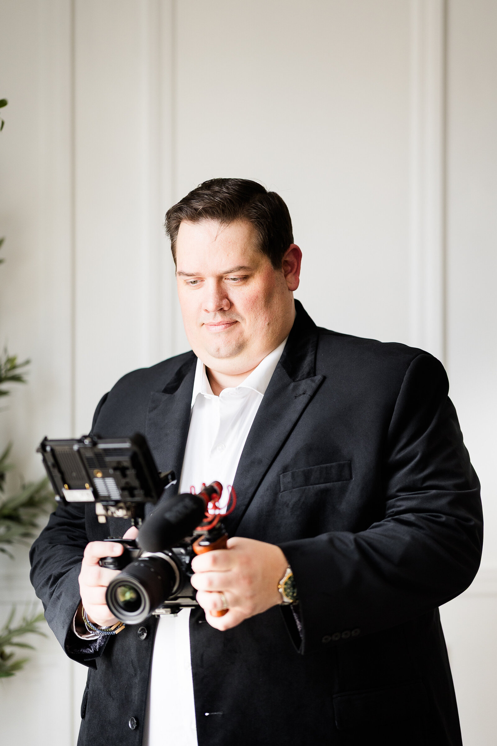 Alex Chapman in a suit at a wedding