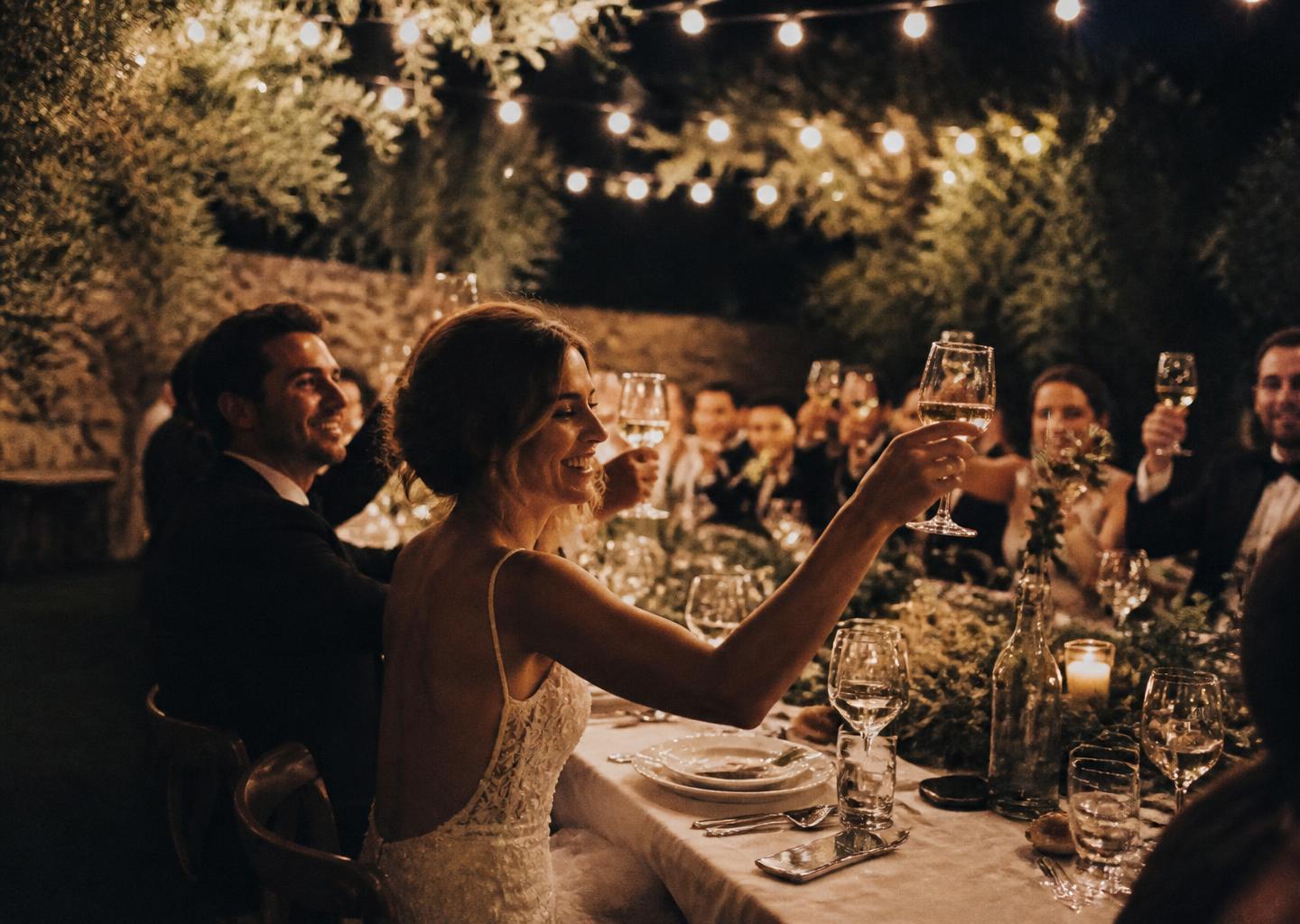 Outdoor reception dinner under string lights